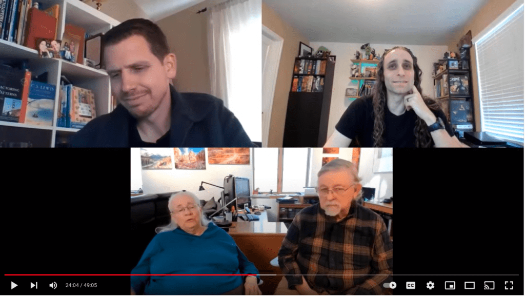 Youtube screenshot. 3 participants in a triagle. 2 top veritices show 2 white males. Bottom vertex shows an older couple.